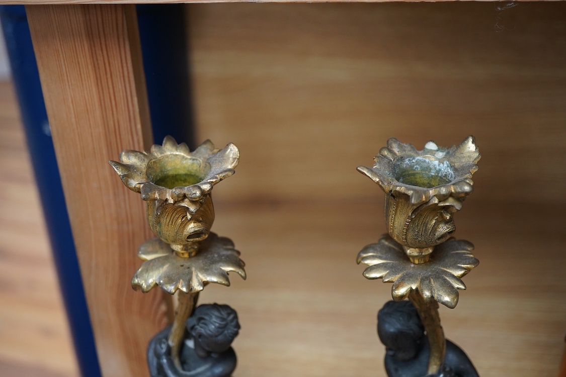 A pair of decorative French ormolu figural candlesticks, 25.5cm high
